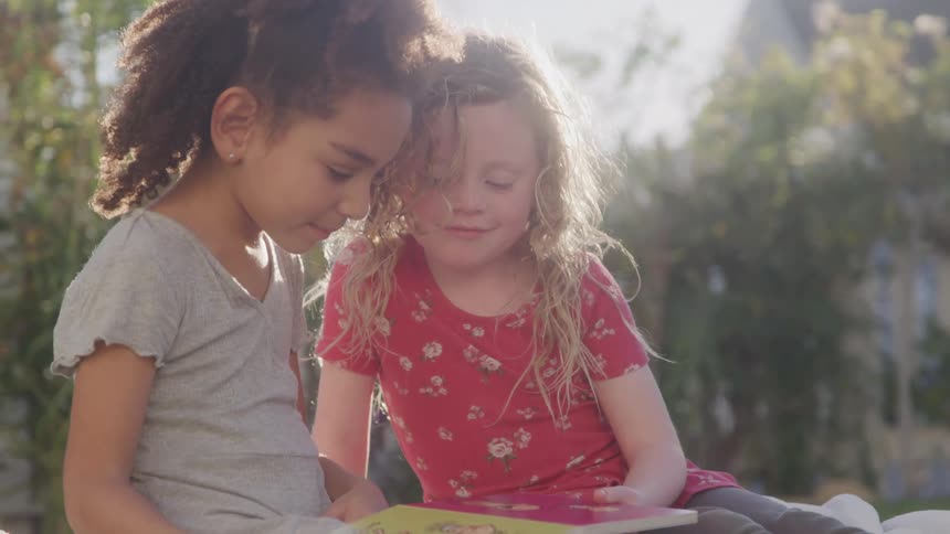 Two little girls in a backyard