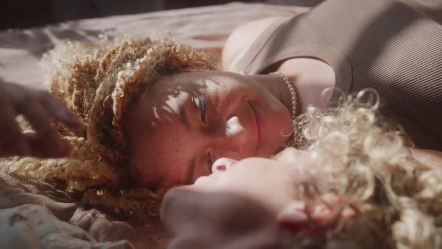 Couple lying together and looking at each other romantically