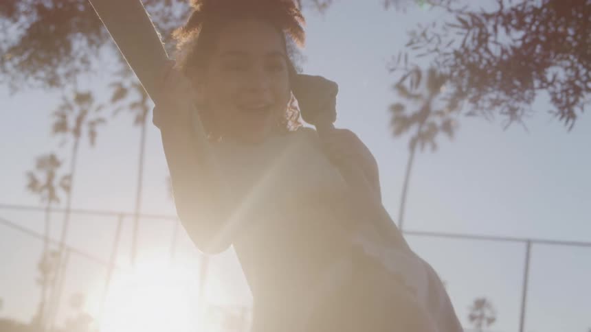 Girl at a using a swing with thick ropes