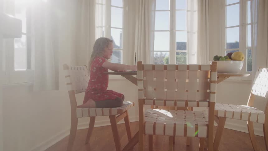 Little girl lying down drawing on the table