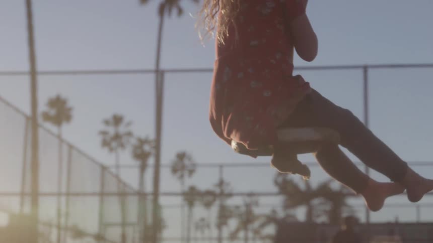 Child playing on a swing