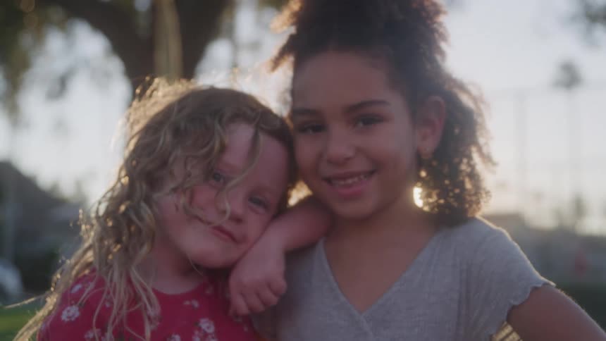 Two little girls looking at each other happily