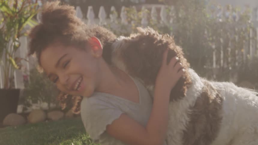 Little girl having fun with a dog