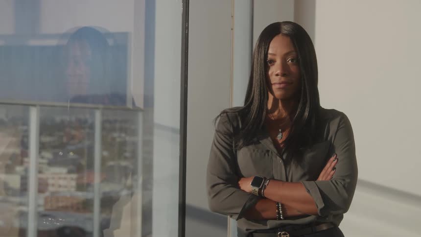 Woman with arms crossed in a panoramic room
