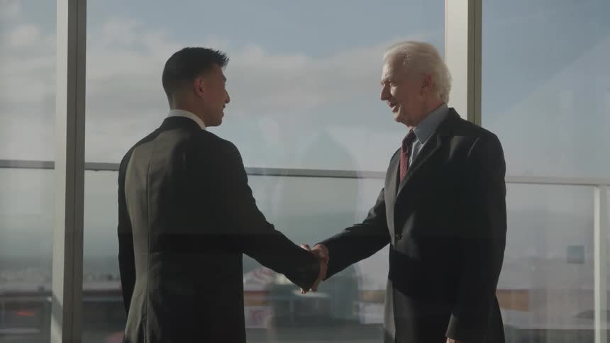 Two men shaking hands in an office