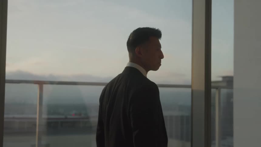 Man in suit walking in a panoramic room in a building