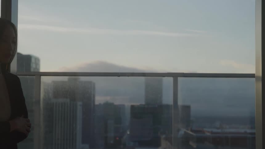 Woman walks nervously near a window