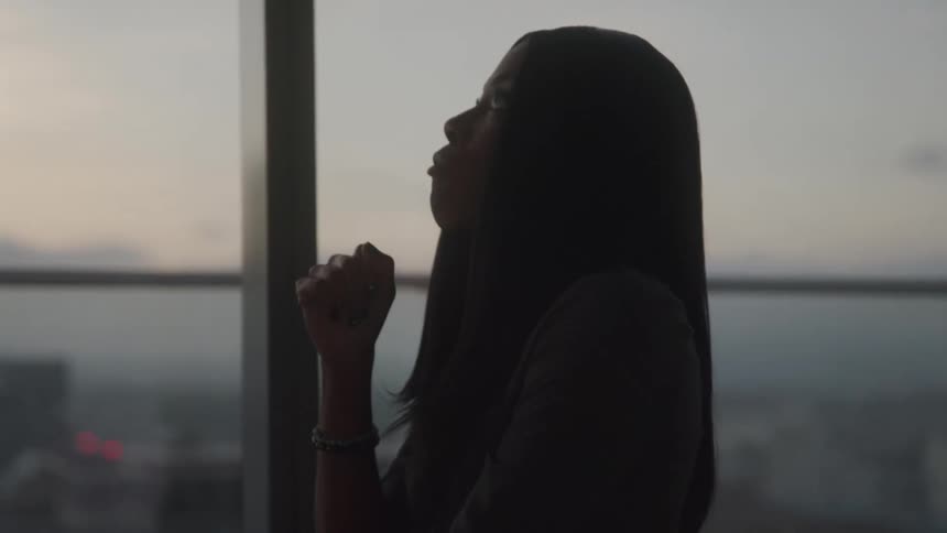 Thoughtful woman walking through a panoramic room