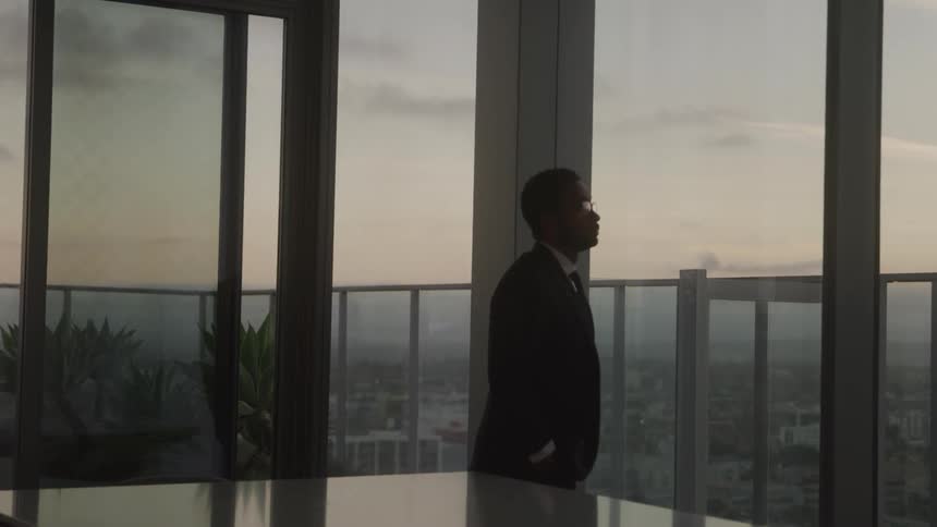 Man walking and thinking in an office
