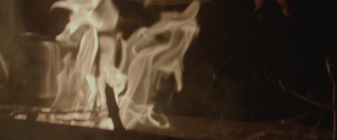 A pot is cooking on a fire