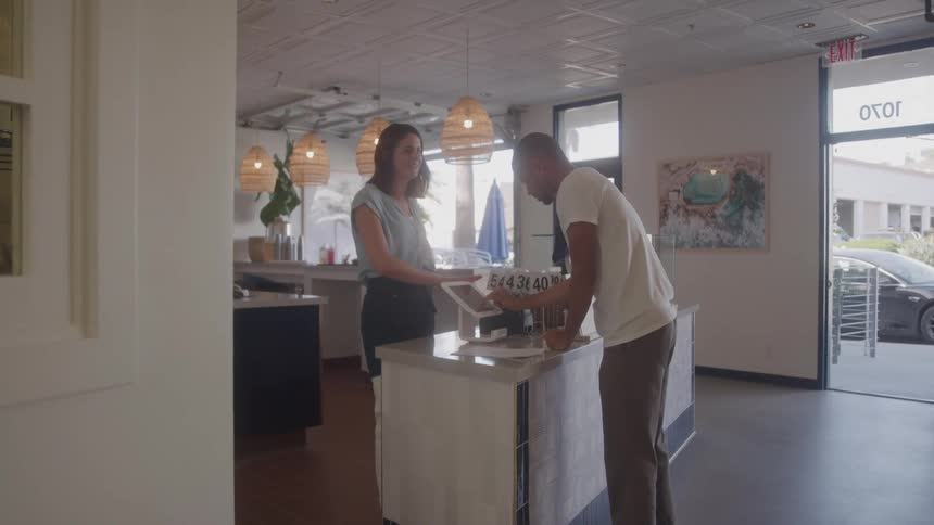 A man pays in the restaurant