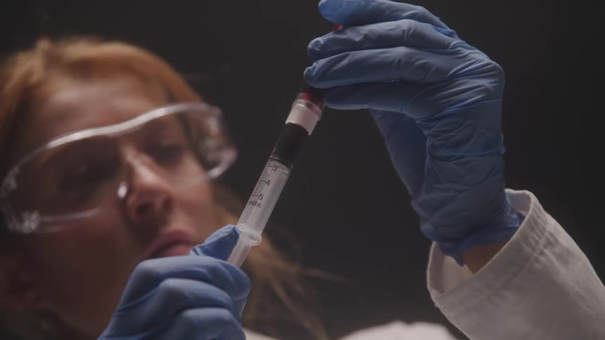 The doctor fills the syringe
