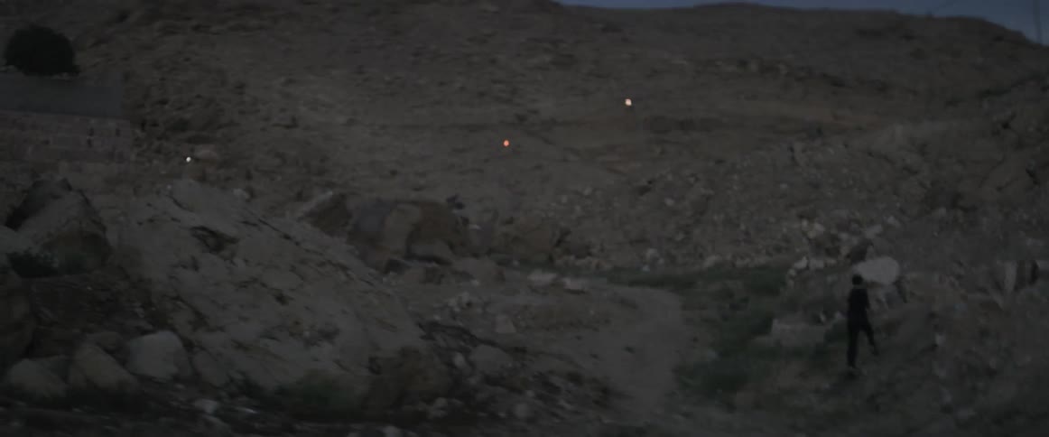 A man is running along the hilly area