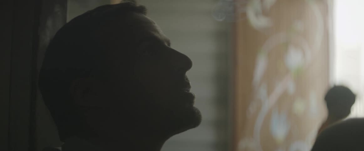 A man takes a long drag from a cigarette