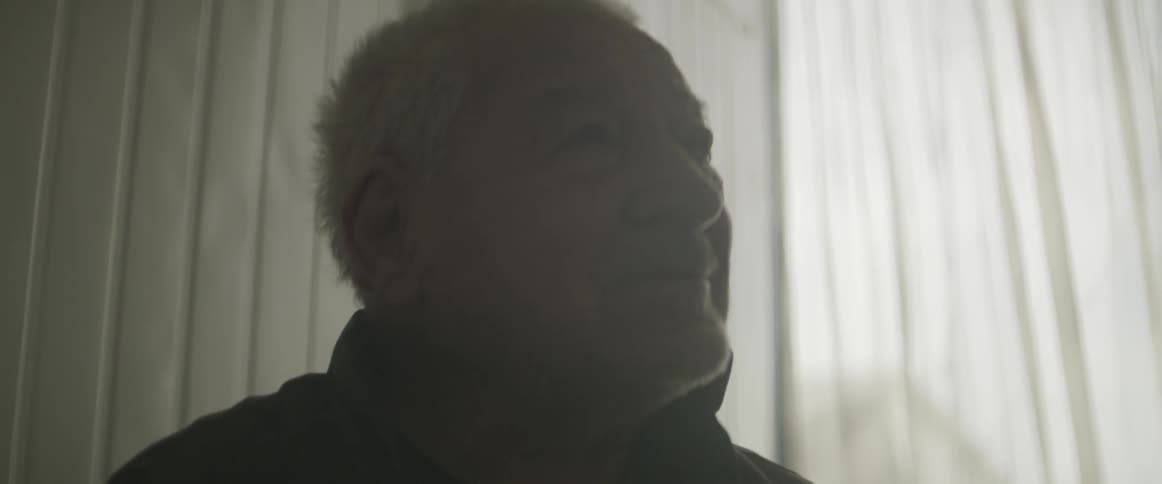 An elderly man smiles
