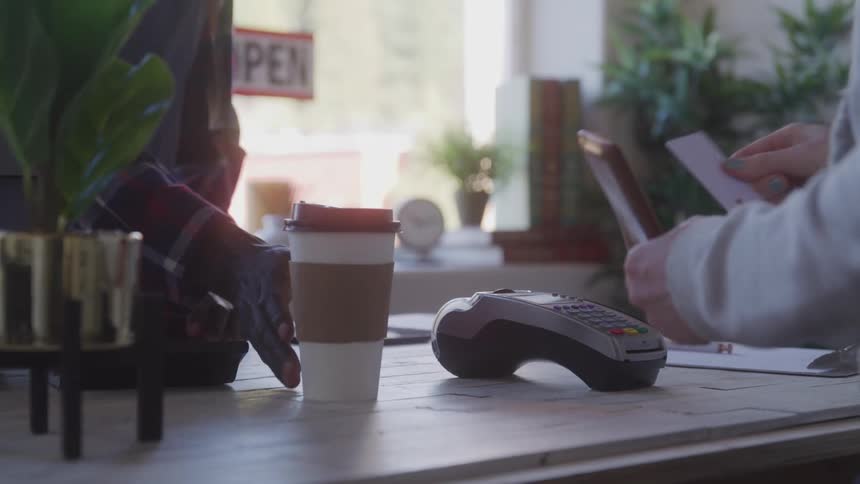 A customer pays for their coffee