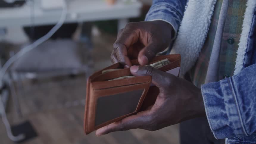 A man rifles through his wallet