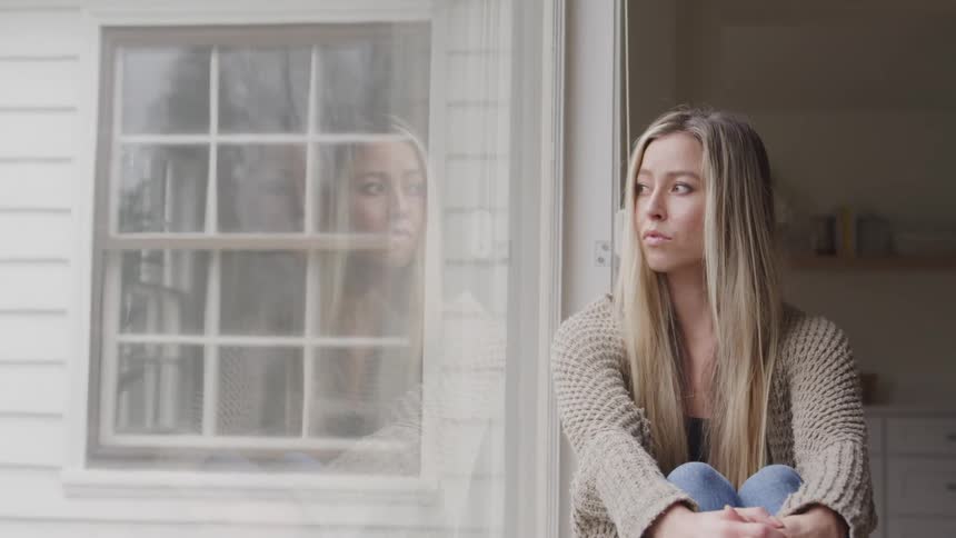 Woman sitting looking out the window