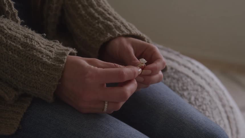 A woman holding an engagement ring