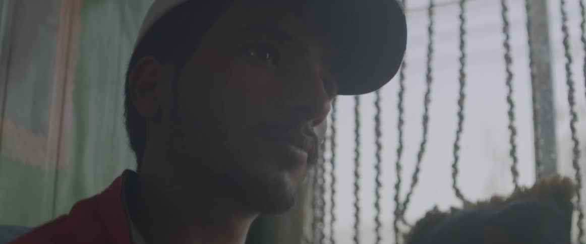 A man sits by a sunny window