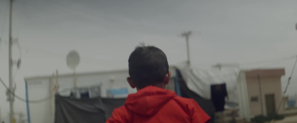 A young boy runs outside