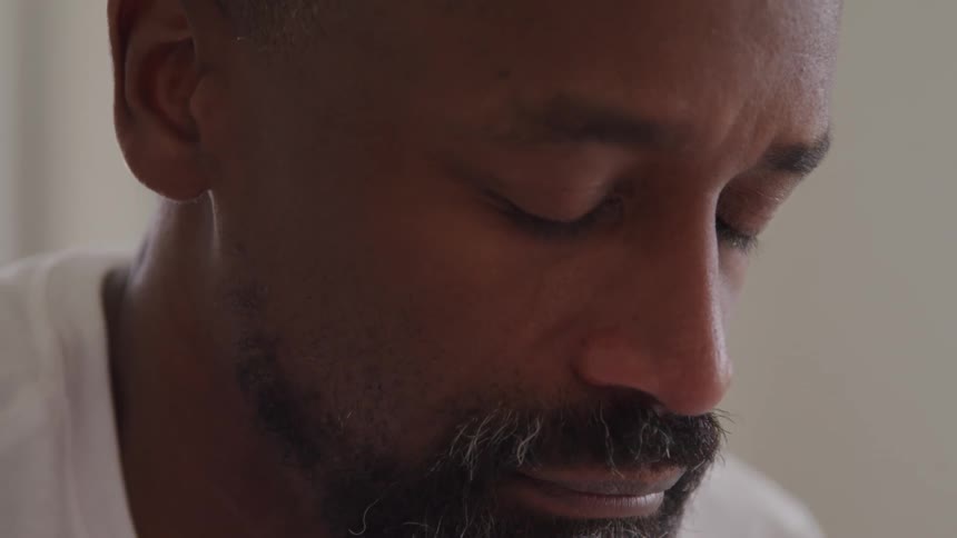 A sad man looks down