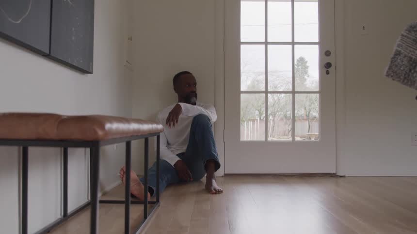 Man sitting in a room of the house on the floor