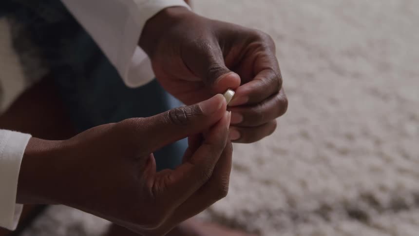 The man is holding a ring with both hands