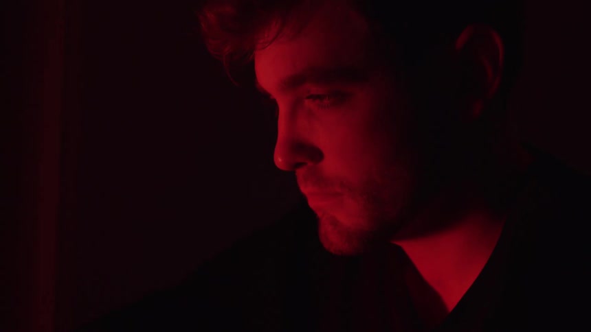 Red light shines on the mans face