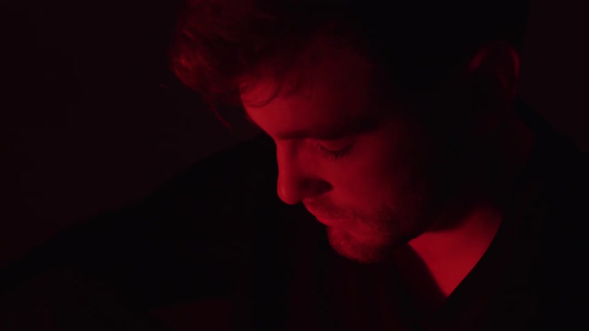 Man in a dark room with red light