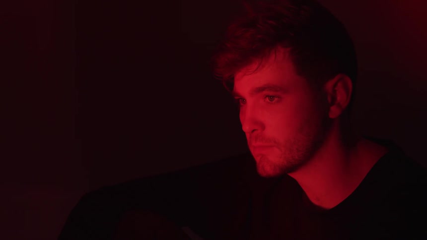 Man inside a dark room with red light
