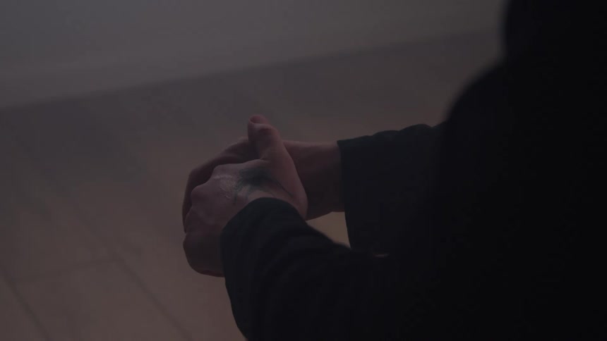 Closeup of a persons hands with a tattoo