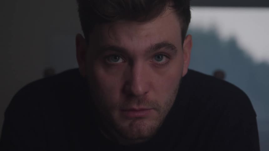 The man blinks and looks up