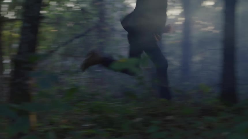 Man running through a forest
