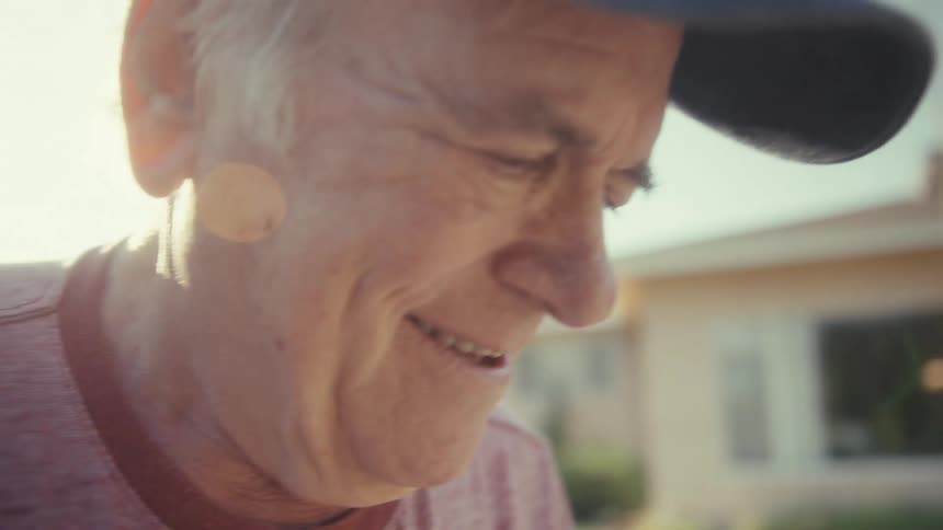Elderly man outdoors walking with happy expression