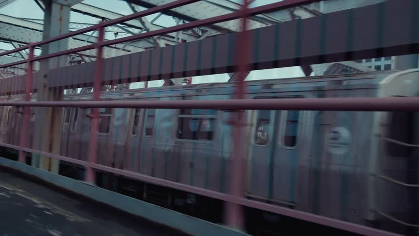 Public transit train crosses a bridge over the water during the daytime