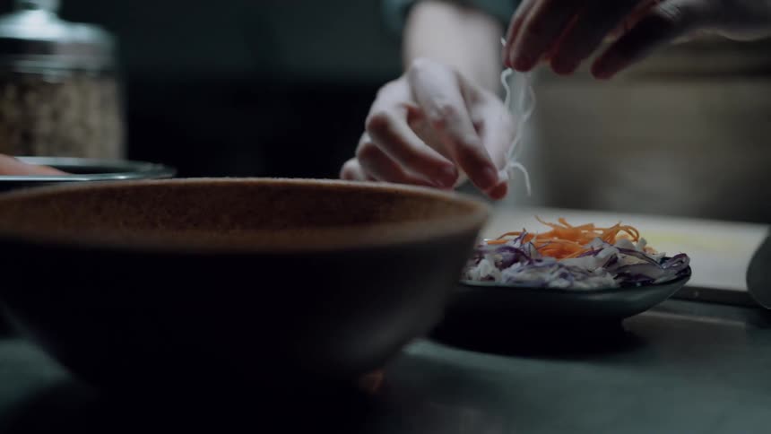 A chef prepares a meal inside the kitchen
