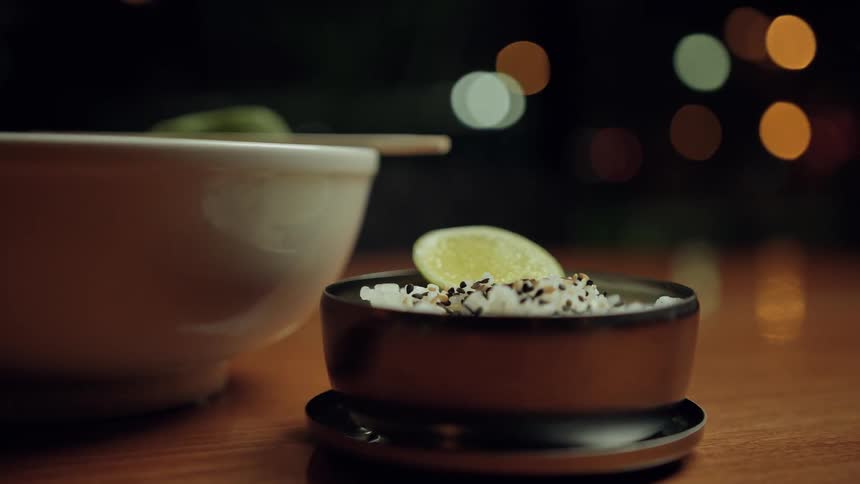 Two bowls of food sit on a wooden surface
