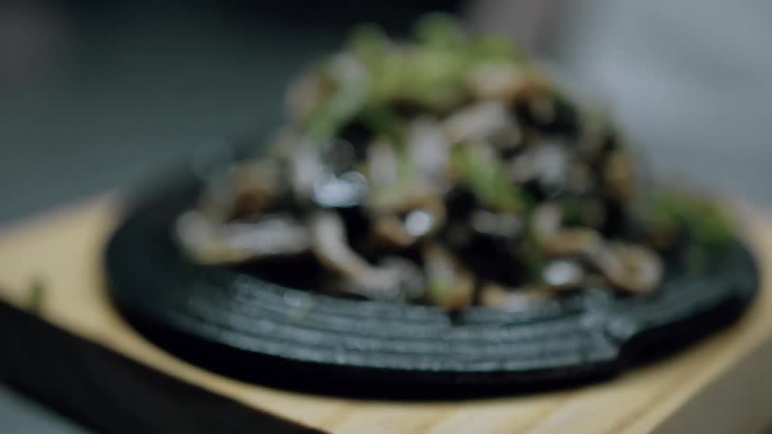 The food is presented on a wood block