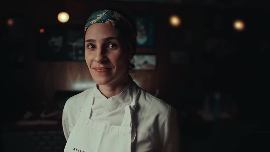The chef is smiling in the restaurant
