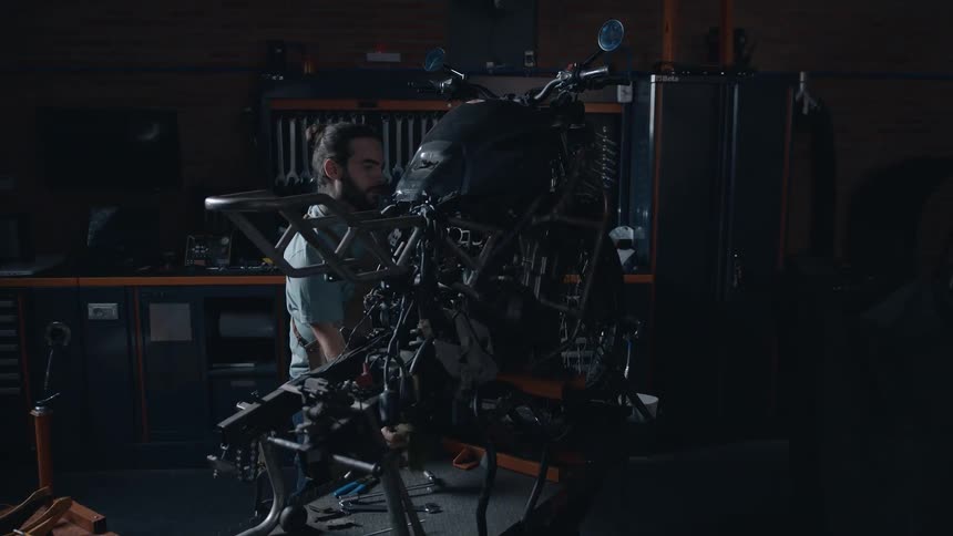 The mechanic is rebuilding a motorcycle