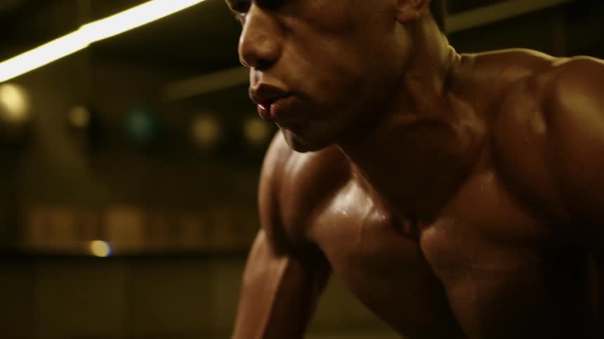 A man is doing pushups in the gym