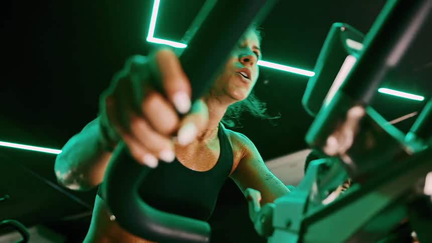 Man and woman are using exercise bikes in the gym