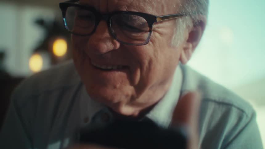 A man begins laughing while reading a paper