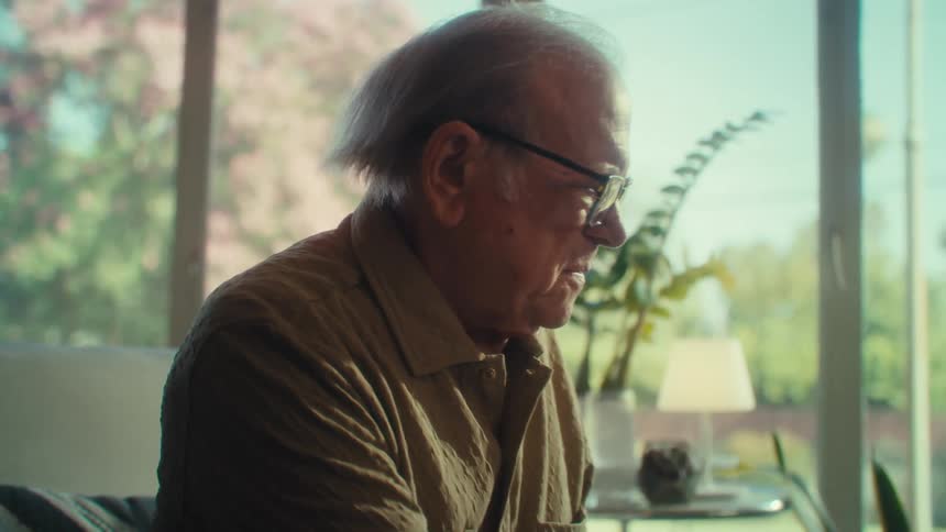Elderly man sitting working with a laptop