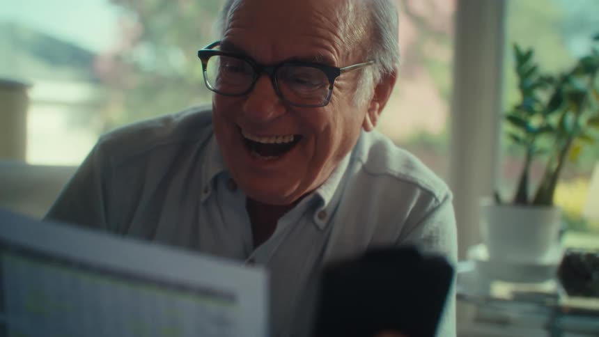 The man becomes surprised when reading a report