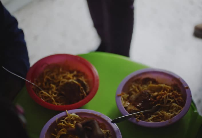 Children are eating spaghetti together