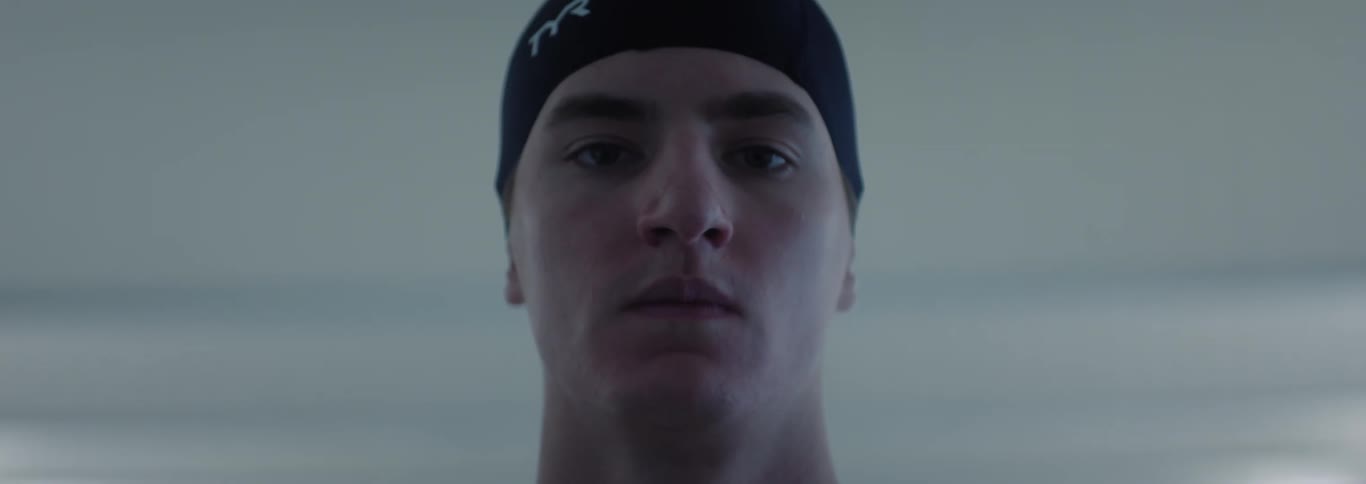 The swimmer blinks his eyes in the building