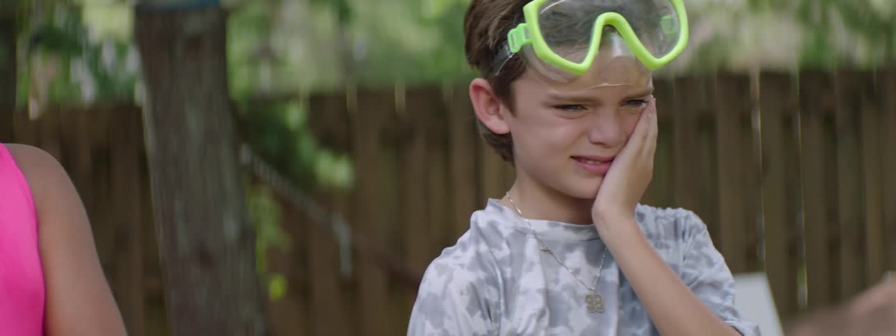 Children in a backyard making faces