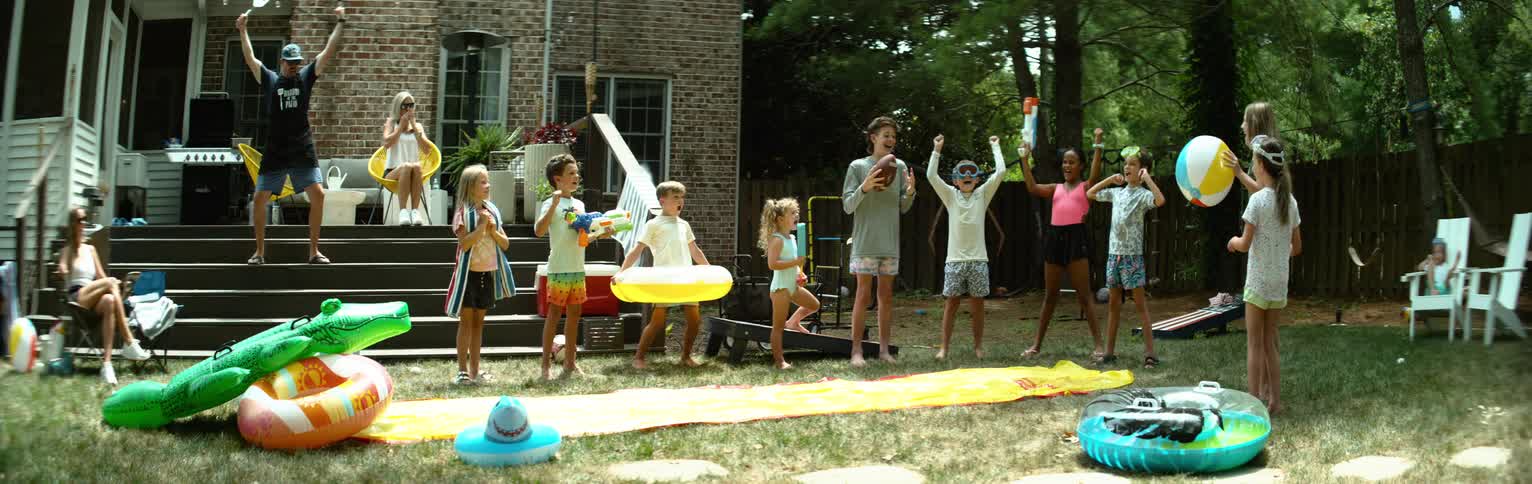 Group of happy children playing in a backyard